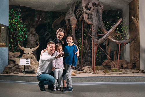 family takes a selfie in the museum